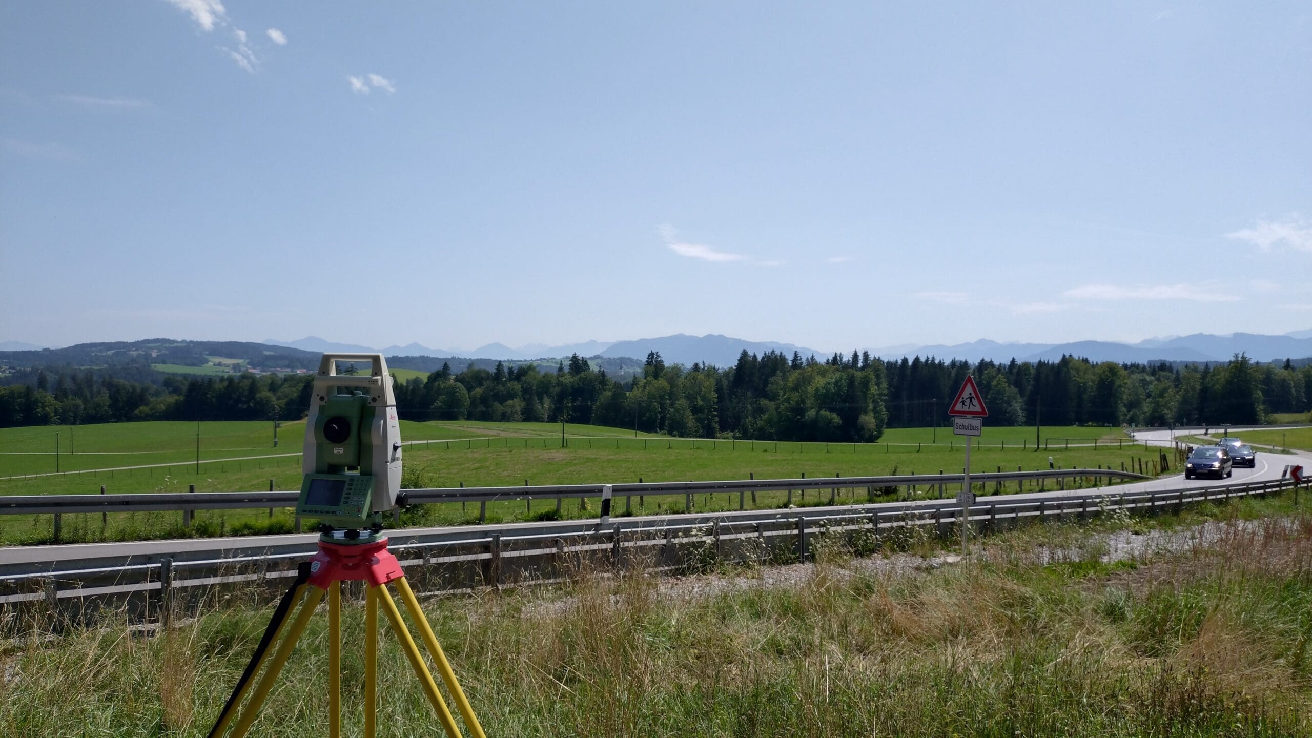 Total station surveying beside highway for road survey services